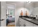 Bright bathroom vanity with quartz countertop, sleek fixtures and a view to bedroom at 749 Golfers Vw, Pittsboro, NC 27312