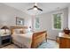 Comfortable bedroom featuring a wood frame bed and two windows providing plenty of natural light at 749 Golfers Vw, Pittsboro, NC 27312