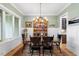Traditional dining room with decorative plates, wood table and chairs and ample natural light at 749 Golfers Vw, Pittsboro, NC 27312