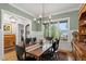 Dining room with large windows offering natural light, wood table, and decorative furnishings at 749 Golfers Vw, Pittsboro, NC 27312