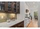 Kitchen featuring stainless steel appliances, custom cabinets, countertops, and view to dining area at 749 Golfers Vw, Pittsboro, NC 27312