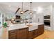 Open concept kitchen with a large island, farmhouse sink, stainless steel appliances, and an open floor plan at 749 Golfers Vw, Pittsboro, NC 27312