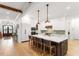 Spacious kitchen with an island, white cabinetry, stainless steel appliances, and hardwood floors at 749 Golfers Vw, Pittsboro, NC 27312