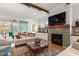 Comfortable living room with a cozy fireplace, hardwood floors, recessed lights, and a smooth transition to the outdoors at 749 Golfers Vw, Pittsboro, NC 27312