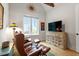 Comfortable living room featuring leather chairs, a large window and stylish decor at 749 Golfers Vw, Pittsboro, NC 27312