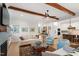Well-lit living room with a fireplace, hardwood floors, comfortable seating, and an open floor plan to the kitchen at 749 Golfers Vw, Pittsboro, NC 27312