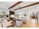 Cozy living room featuring hardwood floors, a fireplace, wood beam ceiling, and comfortable seating with neutral colors at 749 Golfers Vw, Pittsboro, NC 27312