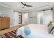 Bright bedroom showcasing hardwood floors and a large dresser with sliding doors to closet and en-suite bath at 749 Golfers Vw, Pittsboro, NC 27312