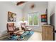 Sitting room with hardwood floors, comfortable leather chairs, and view to nature at 749 Golfers Vw, Pittsboro, NC 27312