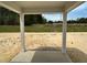 Covered patio with views of the undeveloped backyard and surrounding wooded area at 752 Swim Cave Ln, Wendell, NC 27591