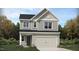 Charming two-story home with gray siding, well-manicured lawn and a two car garage at 761 Swim Cave Ln, Wendell, NC 27591