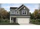 Charming two-story home with gray siding, white trim, and an attached two-car garage at 765 Swim Cave Ln, Wendell, NC 27591