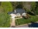 Aerial view of home with a well-manicured lawn and mature trees surrounding the property on a sunny day at 8000 Elderson Ln, Raleigh, NC 27612