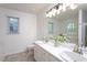 Bright bathroom featuring a double sink vanity and updated fixtures at 8000 Elderson Ln, Raleigh, NC 27612