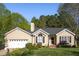 Charming single-story home with well-maintained landscaping, attached garage, and a welcoming front entrance at 8000 Elderson Ln, Raleigh, NC 27612