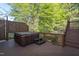 Backyard deck featuring a hot tub, perfect for outdoor entertaining and relaxation with surrounding trees at 8000 Elderson Ln, Raleigh, NC 27612