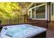 Enjoy the outdoors in this private hot tub on the backyard deck with screened porch in the background at 8000 Elderson Ln, Raleigh, NC 27612