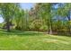Green backyard with a rustic wooden fence, offering a large space for recreation and outdoor activities at 8059 Hogan Dr, Wake Forest, NC 27587
