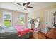 Bedroom featuring wood floors, ceiling fan, large windows, and neutral colored walls at 8059 Hogan Dr, Wake Forest, NC 27587