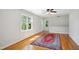 Bright bedroom features hardwood floors, a ceiling fan, and plenty of natural light at 8059 Hogan Dr, Wake Forest, NC 27587