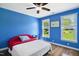 Blue bedroom featuring hardwood floors, and windows offering outdoor views at 8059 Hogan Dr, Wake Forest, NC 27587