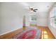 Spacious bedroom with hardwood floors, light gray walls, and two large windows at 8059 Hogan Dr, Wake Forest, NC 27587