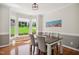 Cozy breakfast nook with bay window, hardwood floors, and a modern chandelier creating a charming dining space at 8059 Hogan Dr, Wake Forest, NC 27587