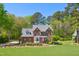 Beautiful two-story brick home surrounded by lush greenery, offering privacy and curb appeal at 8059 Hogan Dr, Wake Forest, NC 27587