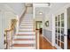 Elegant foyer with hardwood floors, a staircase, and neutral-toned walls creating a bright and inviting atmosphere at 8059 Hogan Dr, Wake Forest, NC 27587