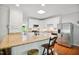 Modern kitchen featuring granite countertops, white cabinetry, and stainless steel appliances, perfect for cooking at 8059 Hogan Dr, Wake Forest, NC 27587