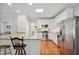 Bright eat-in kitchen featuring granite countertops, stainless steel appliances, and hardwood floors at 8059 Hogan Dr, Wake Forest, NC 27587