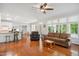Open-concept living space with hardwood floors, large windows, and ample seating for Gathering and guests at 8059 Hogan Dr, Wake Forest, NC 27587