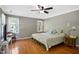 Spacious main bedroom featuring hardwood floors, a ceiling fan, and sunny windows at 8059 Hogan Dr, Wake Forest, NC 27587