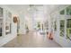 Open sunroom with tile floor, white frame windows, and fan at 8059 Hogan Dr, Wake Forest, NC 27587