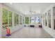Bright sunroom with tile floor, lots of windows, and a ceiling fan at 8059 Hogan Dr, Wake Forest, NC 27587