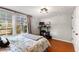 Bright bedroom featuring hardwood floors, large windows, and neutral wall paint at 812 Northclift Dr, Raleigh, NC 27609