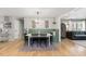 Open-concept dining area with hardwood floors, stylish decor, and a cozy banquette at 812 Northclift Dr, Raleigh, NC 27609