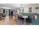 Open-concept dining area with hardwood floors, stylish decor, and a cozy banquette at 812 Northclift Dr, Raleigh, NC 27609
