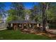 Charming single-story brick home with a manicured lawn and mature trees at 812 Northclift Dr, Raleigh, NC 27609