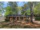 Charming single-story brick home with a manicured lawn and mature trees at 812 Northclift Dr, Raleigh, NC 27609