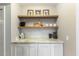 Kitchenette with floating wood shelves, subway tile backsplash, and granite countertop at 812 Northclift Dr, Raleigh, NC 27609