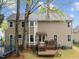 Backyard featuring a deck with outdoor seating, a well-maintained lawn, and mature shade trees at 8921 Walking Stick Trl, Raleigh, NC 27615
