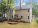 Backyard featuring a deck, well-maintained lawn, mature trees, and the home's exterior at 8921 Walking Stick Trl, Raleigh, NC 27615