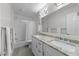 Bright bathroom with granite counters, double sinks, white cabinets, and a shower-tub combo at 8921 Walking Stick Trl, Raleigh, NC 27615
