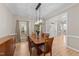 Elegant dining room features hardwood floors, modern lighting, and ample space for entertaining at 8921 Walking Stick Trl, Raleigh, NC 27615