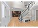 Inviting foyer with gleaming hardwood floors, staircase, and a built-in office space at 8921 Walking Stick Trl, Raleigh, NC 27615