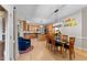 Modern kitchen flowing into a dining area, featuring stainless steel appliances and a large island at 8921 Walking Stick Trl, Raleigh, NC 27615