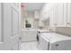 Convenient laundry room with ample storage and a utility sink at 8921 Walking Stick Trl, Raleigh, NC 27615