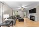 Spacious living room featuring a fireplace, large sectional sofa, and hardwood floors at 8921 Walking Stick Trl, Raleigh, NC 27615
