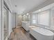 Luxurious main bathroom featuring a soaking tub, walk-in shower, and double vanity at 8921 Walking Stick Trl, Raleigh, NC 27615